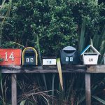 six assorted-color mail boxes